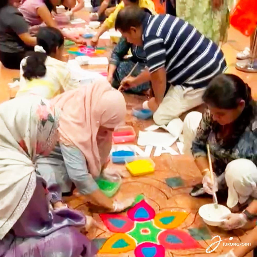 Community members admiring the finished rangoli artwork.