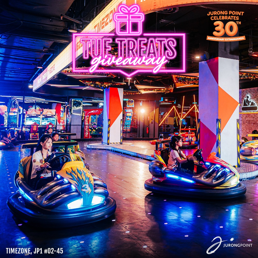 Two people laughing and having fun on a colorful bumper car ride, suggesting excitement and speed.