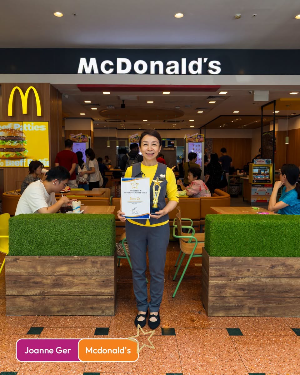 Joanne Ger from McDonald's holding award certificate