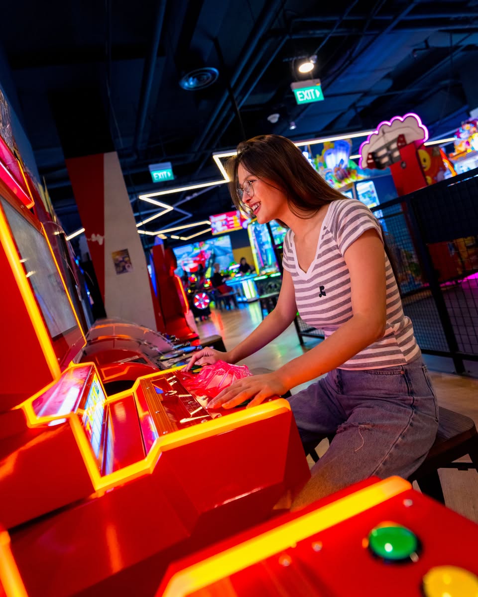 Player enjoying arcade games at Timezone Jurong Point