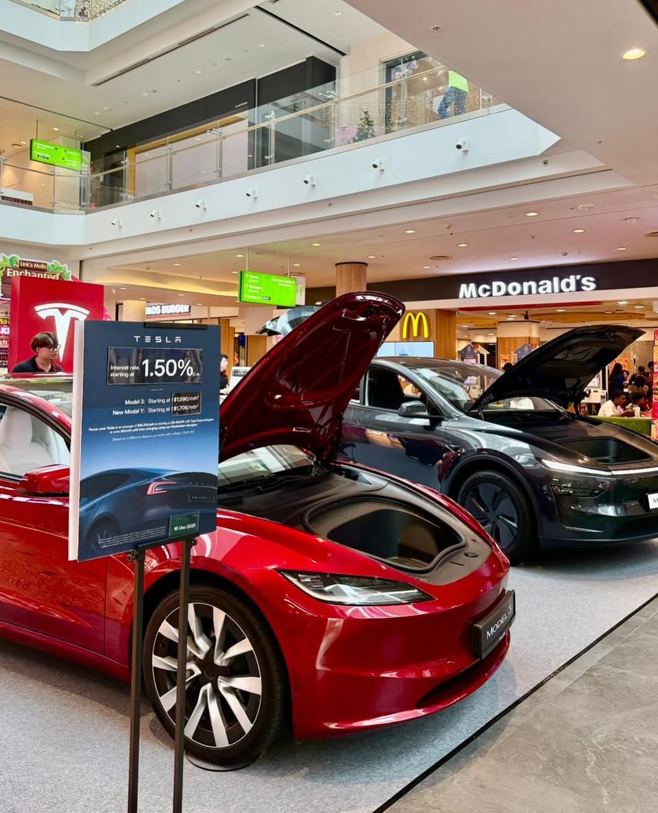 Tesla light show in progress, illuminating a car
