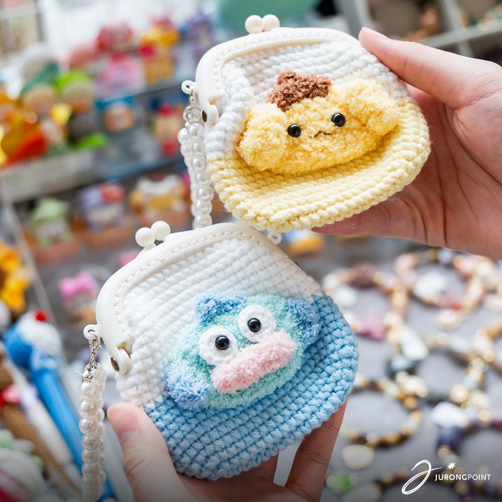 An artisan engaging with a visitor at their craft market stall